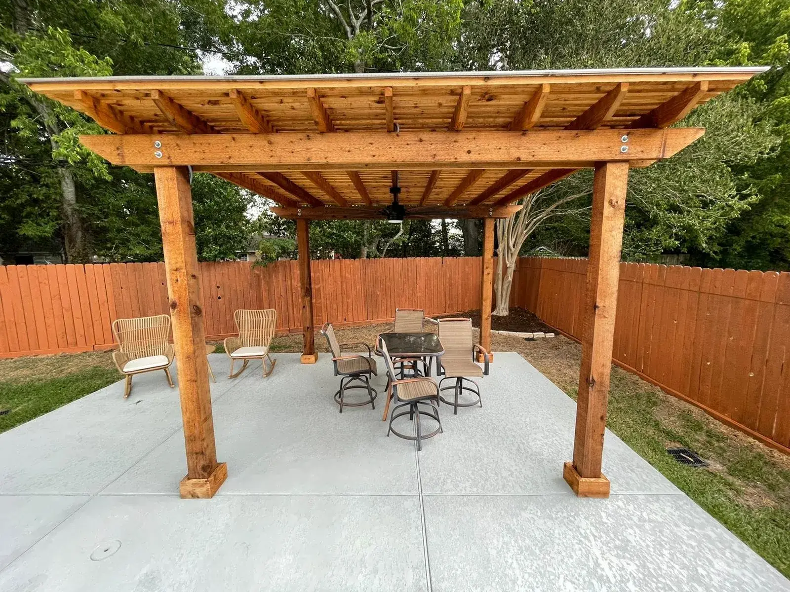 Custom cedar pergola over a poolside patio in a Houston-area backyard outdoor living project