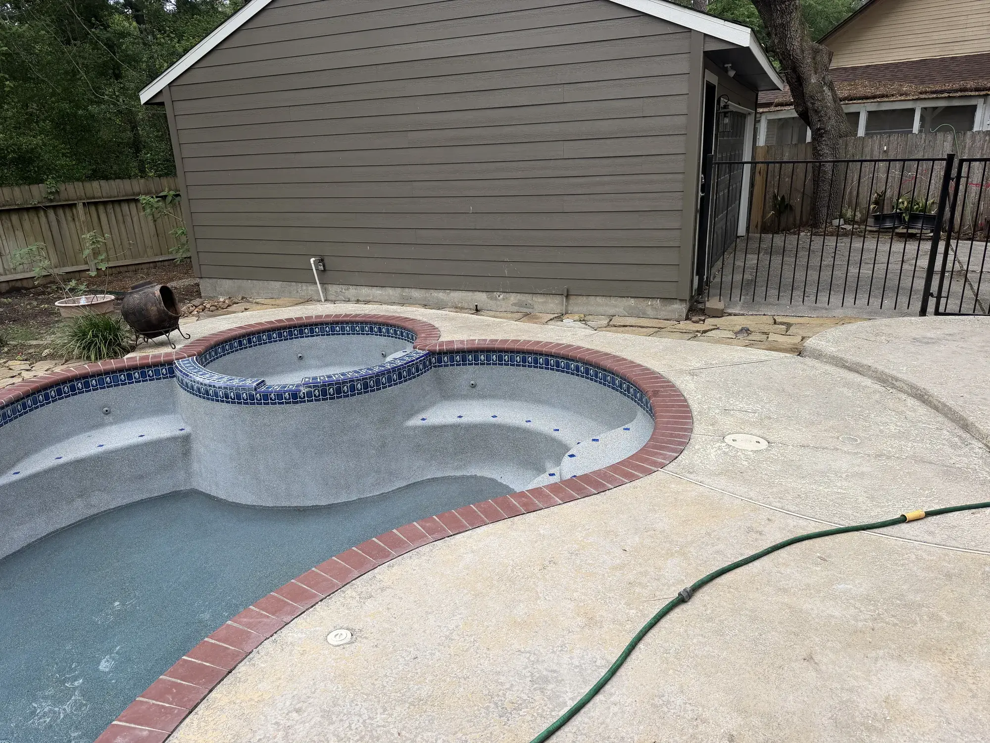 Luxury backyard swimming pool with deck jets and modern coping in East Texas